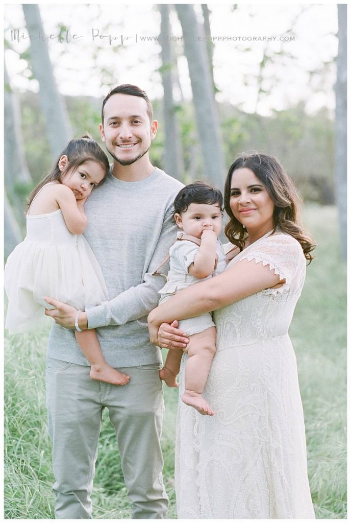 family of four smiling at camera