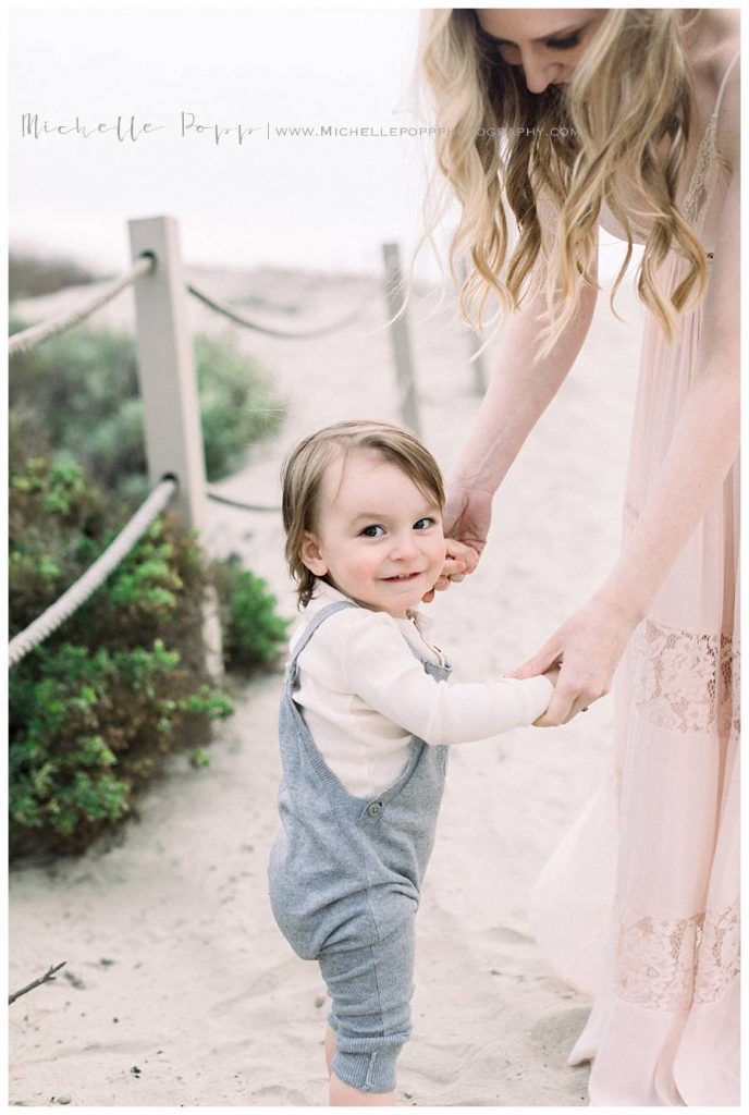 mom holding baby boys hands