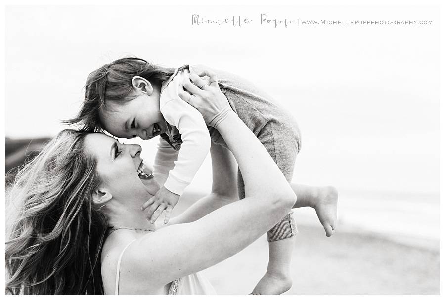 black and white of mom holding baby boy