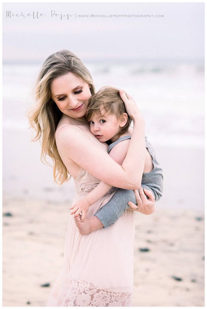 mom holding baby boy in arms