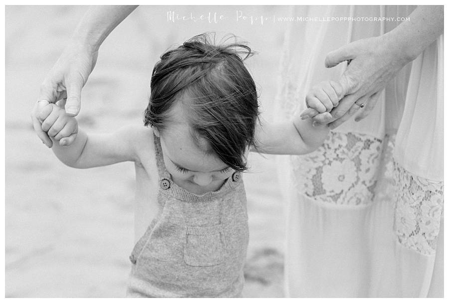 black and white of toddler boy looking down