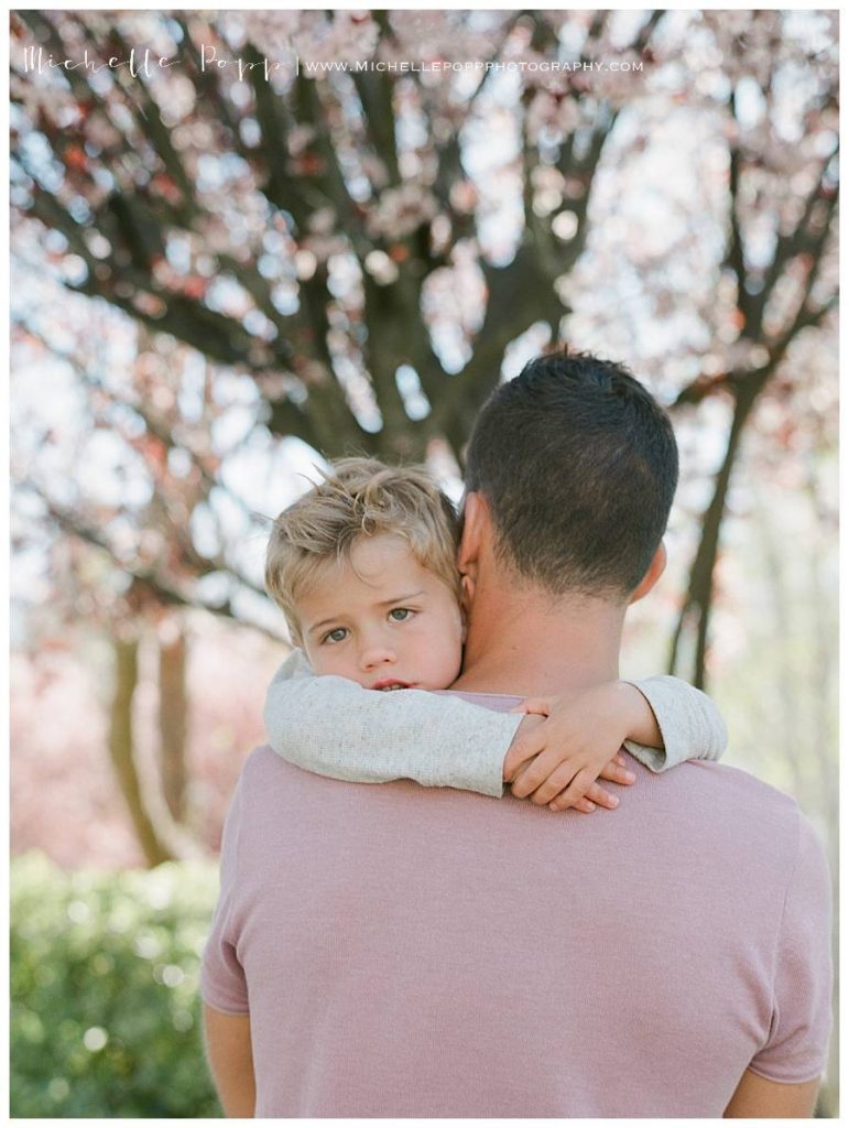 dad holding son in arms