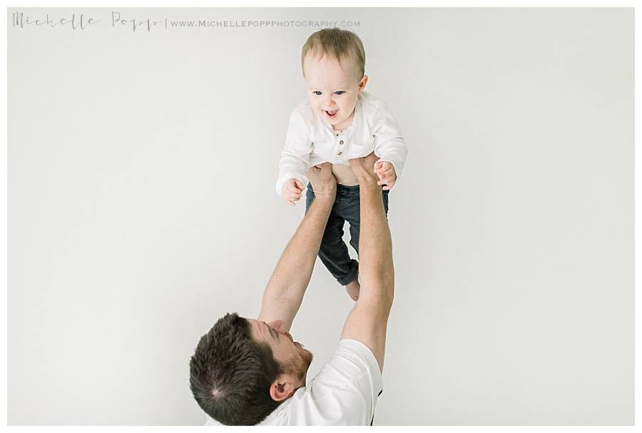 dad lifting son into air