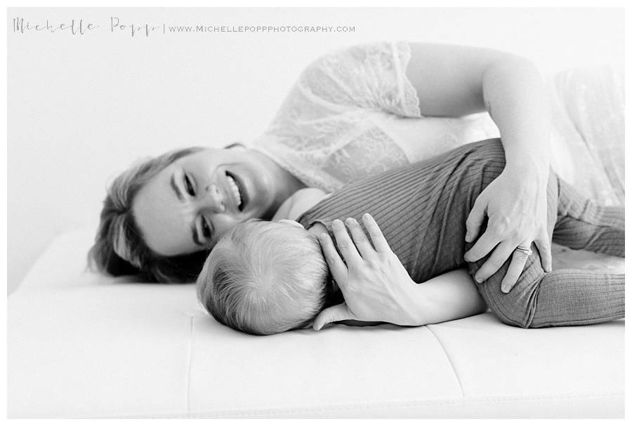 black and white mom and baby on bed
