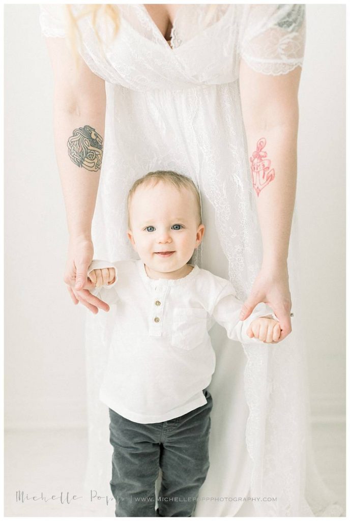 mom holding toddler boys hands