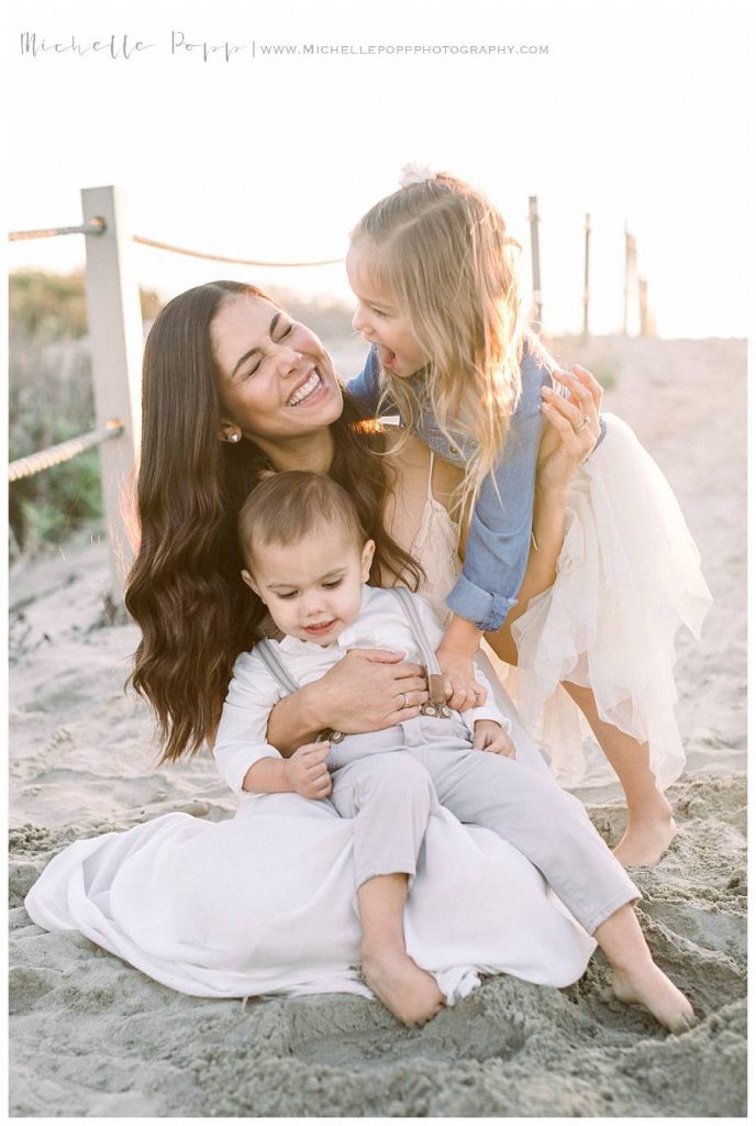 mom holding son while laughing