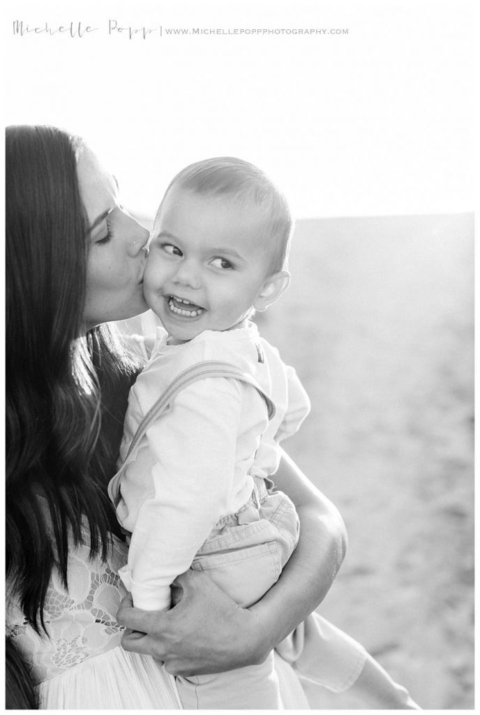 mom kissing baby boy on cheek