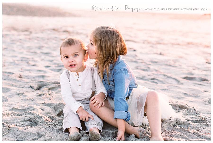 toddler girl kissing brother's cheek