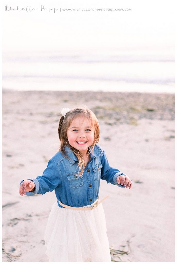little girl twirling in the sand