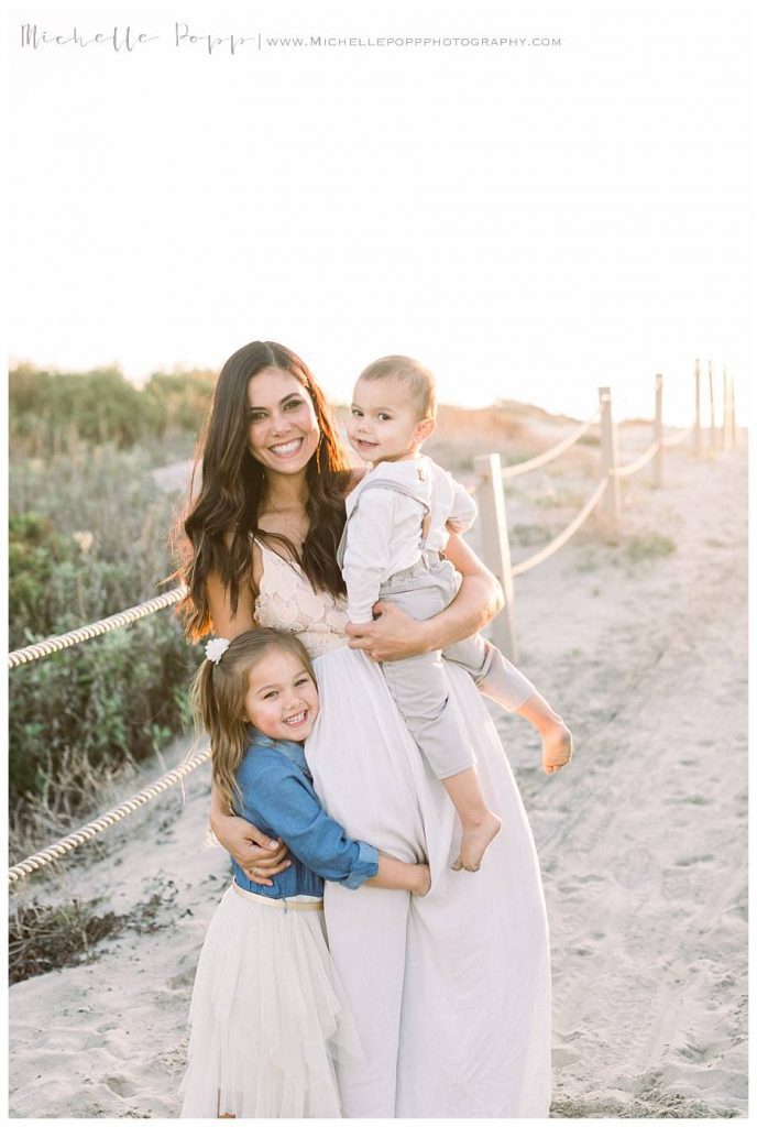 mom smiling at camera holding her babies