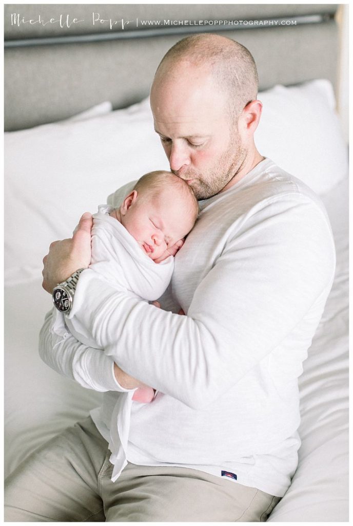 dad holding baby boy in arms