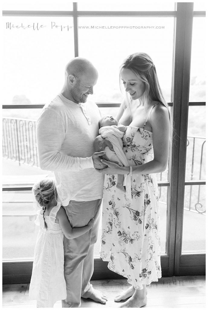 black and white of family in front of window