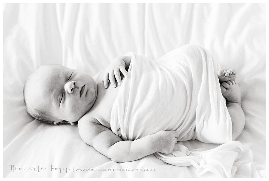 newborn baby boy on bed