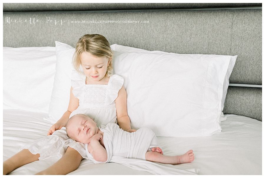 little girl with baby brother on lap