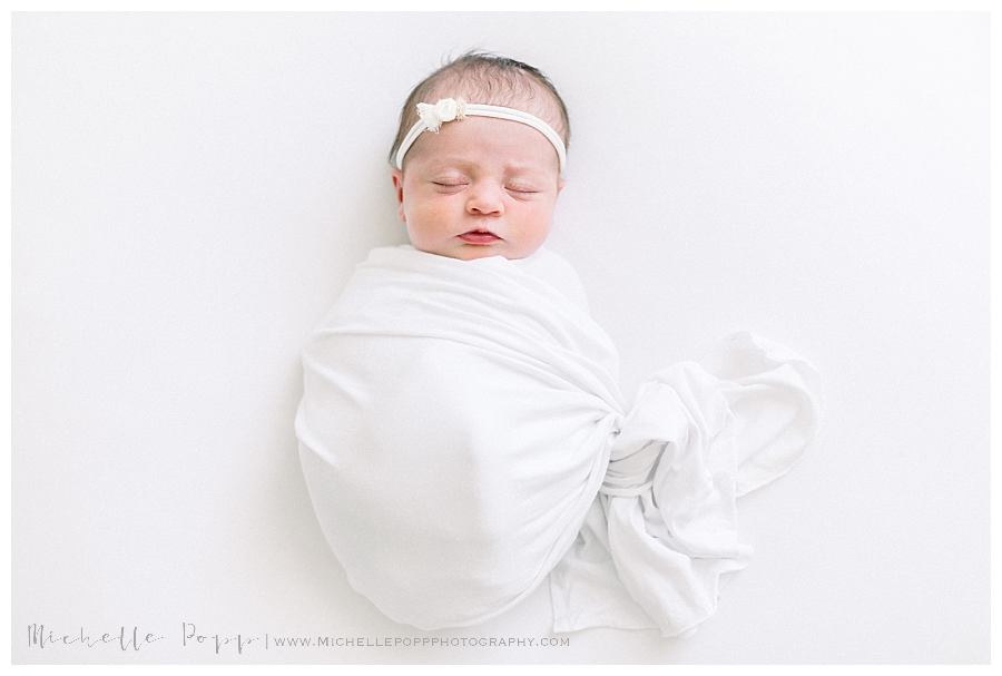 sleeping newborn in swaddle