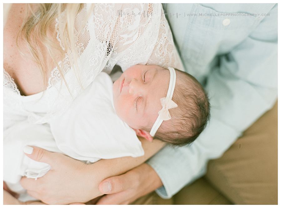 newborn baby girl asleep in moms arms