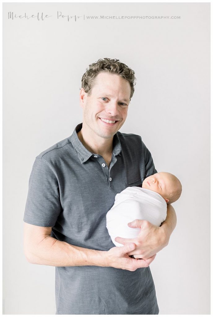 dad holding new baby