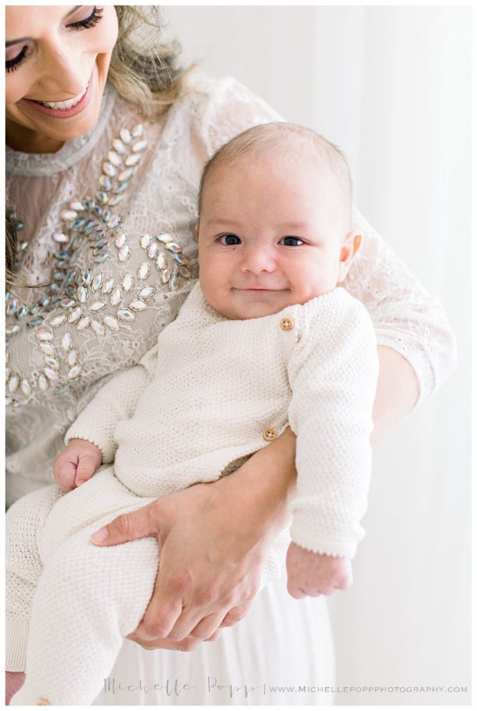 mom holding baby in arms 