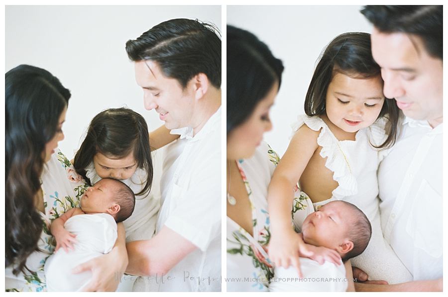 toddler girl being held by parents