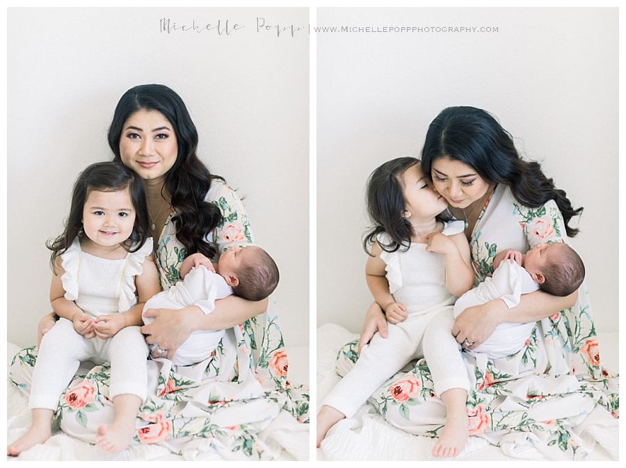 mom holding two kids on lap