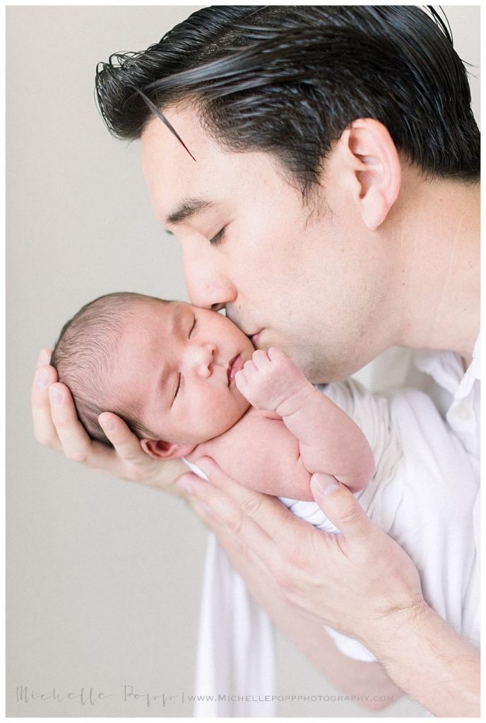 dad holding new baby