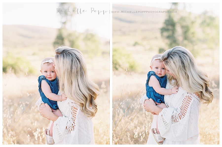 mom giving baby girl kisses