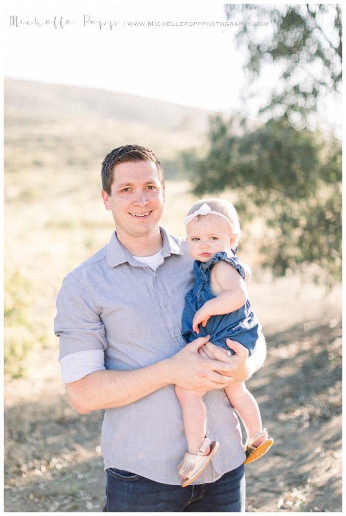 dad holding baby girl