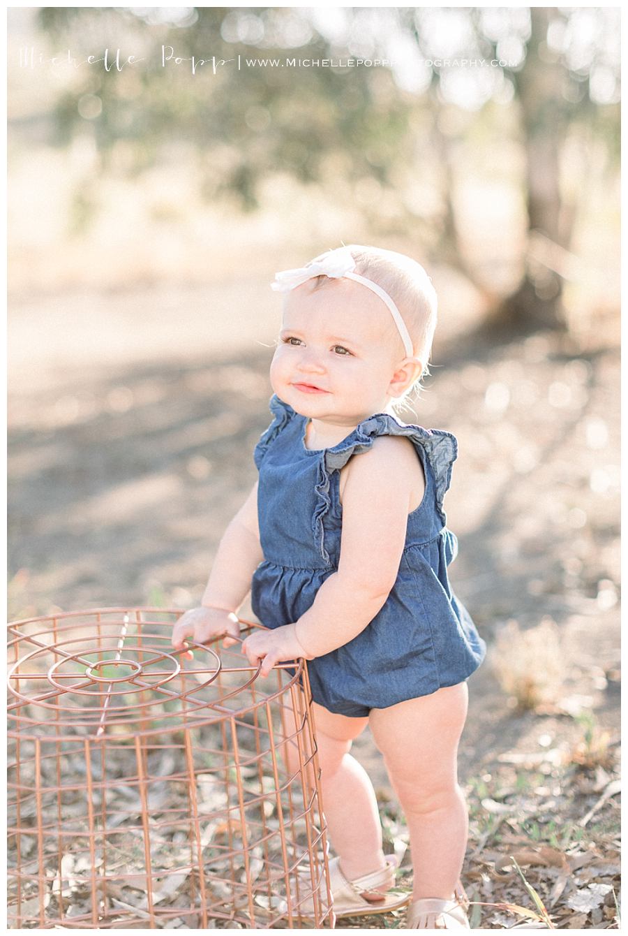 girl in blue romper in field