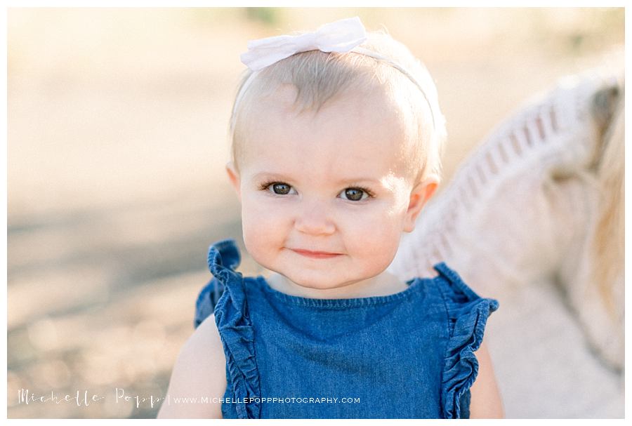 baby girl in blue romper