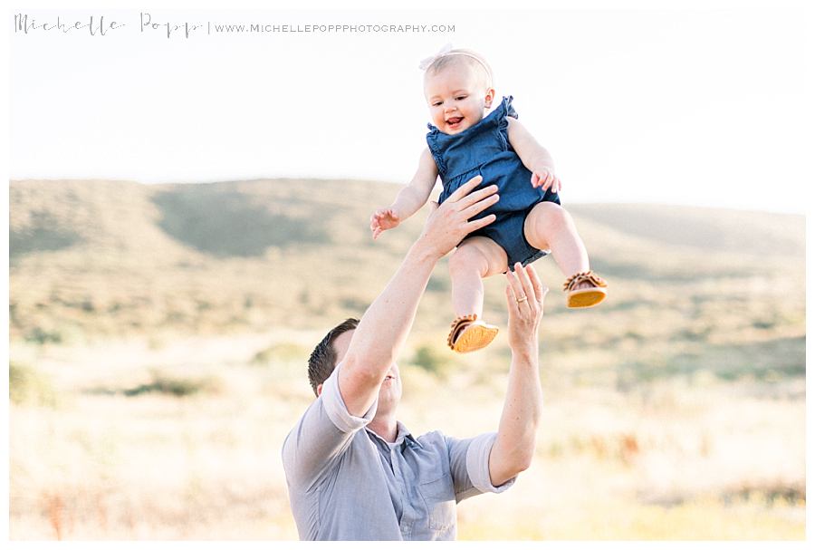 dad swinging daughter into air