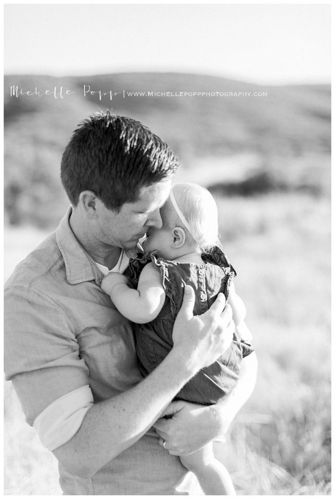 black and white dad snuggling baby girl