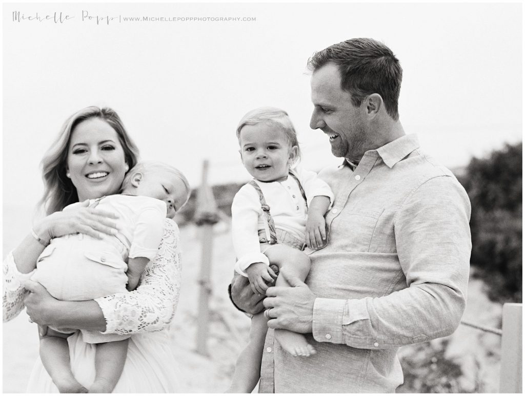 black and white mom and dad holding boys