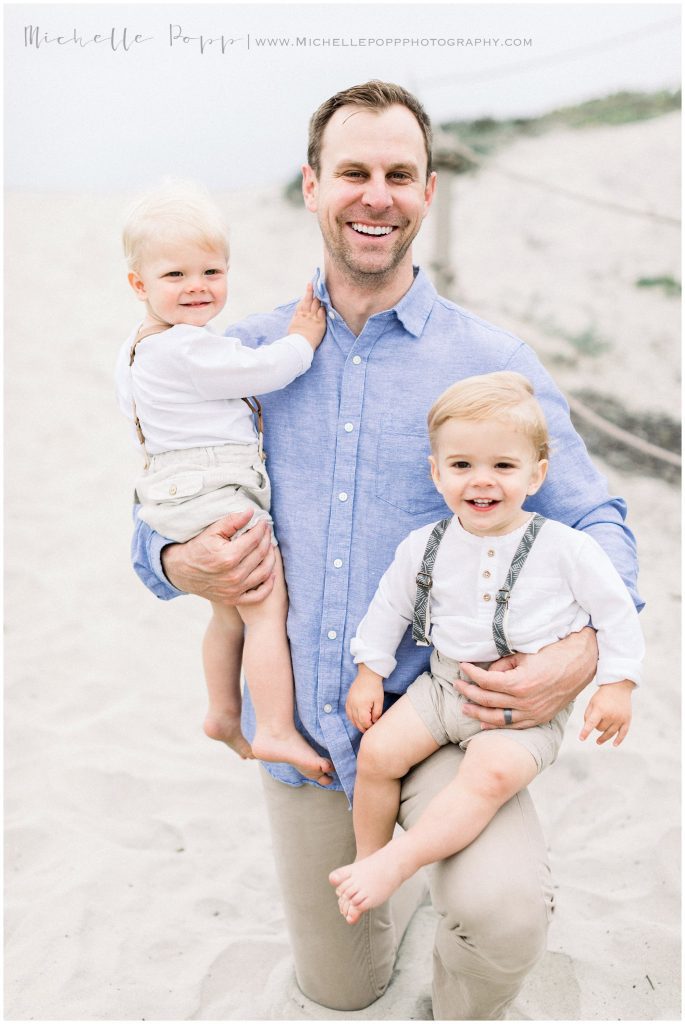 dad holding twins in arms