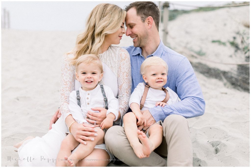 parents holding boys on lap