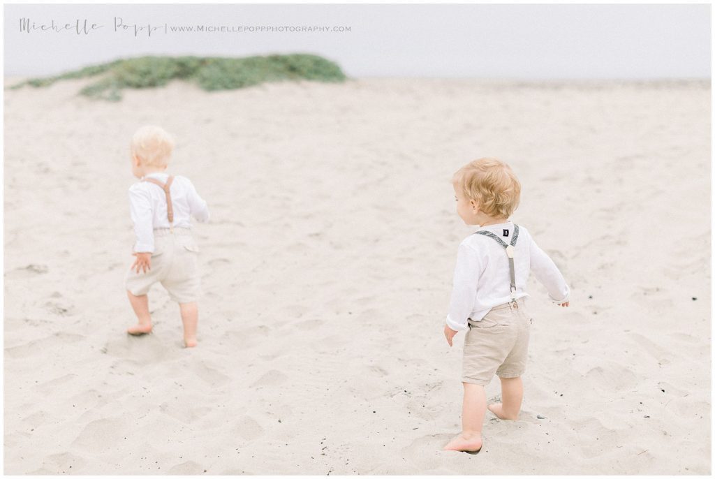 twin boys running on beach