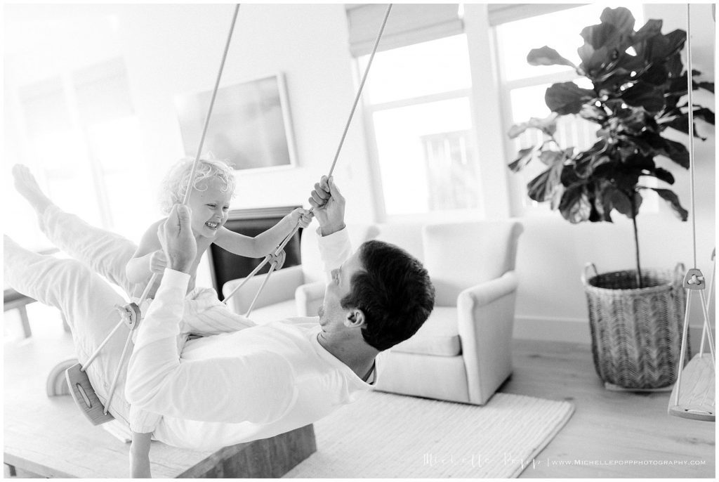 encinitas dad swinging with baby on swing