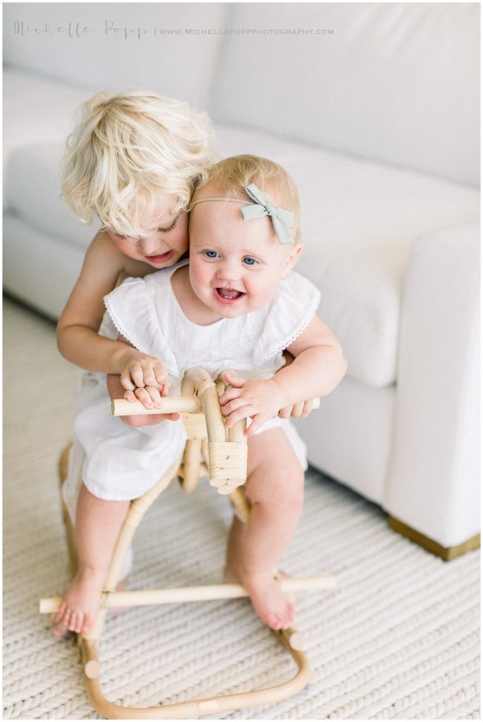 brother and sister on a rocking horse