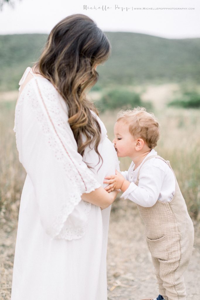 son kissing mom's belly