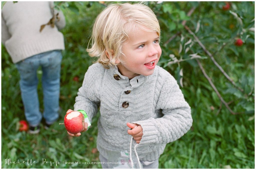 toddler boy holding apple