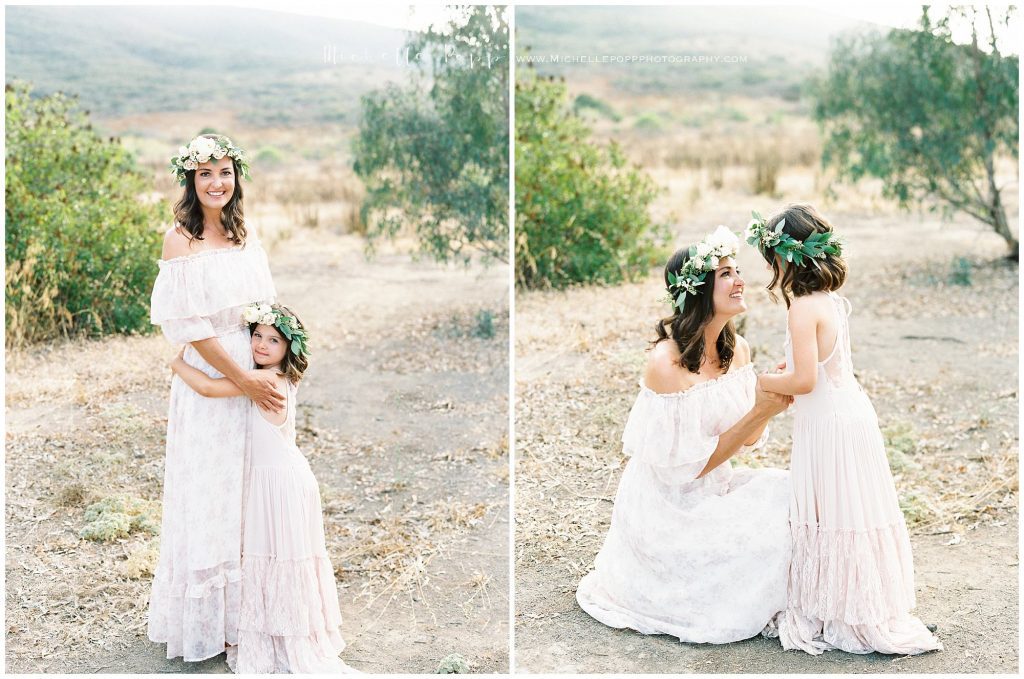 mom and daughter holding hands in a field