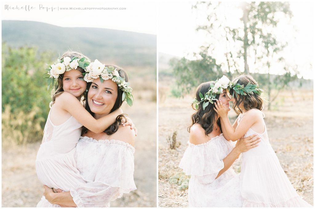 mom and daughter smiling at each other in a field