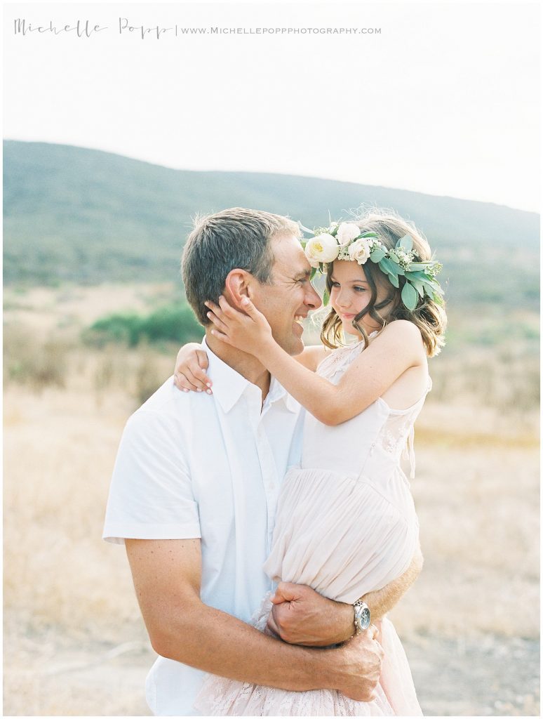 dad and daughter spinning in a field