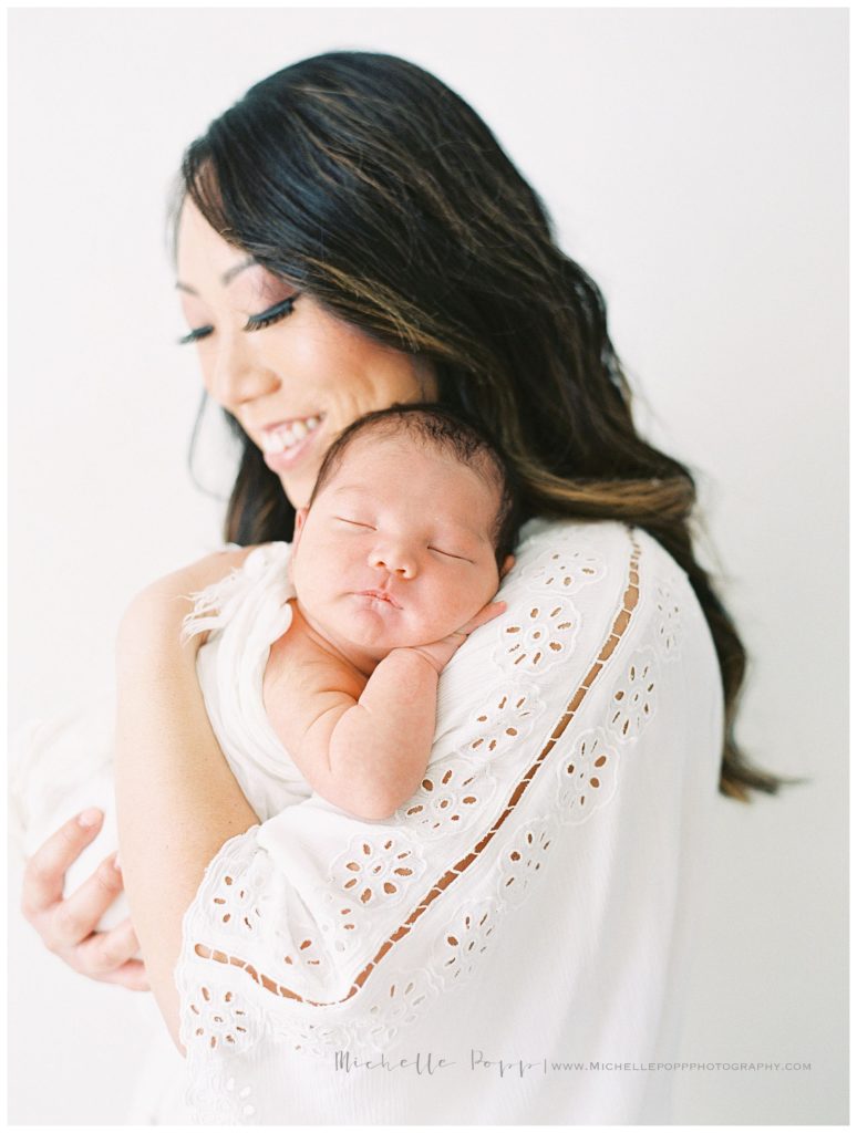 newborn baby sleeping on mom's chest