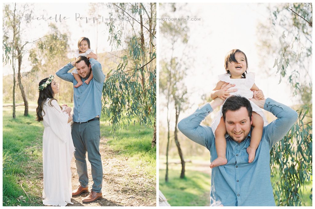 big sister on dad's shoulders