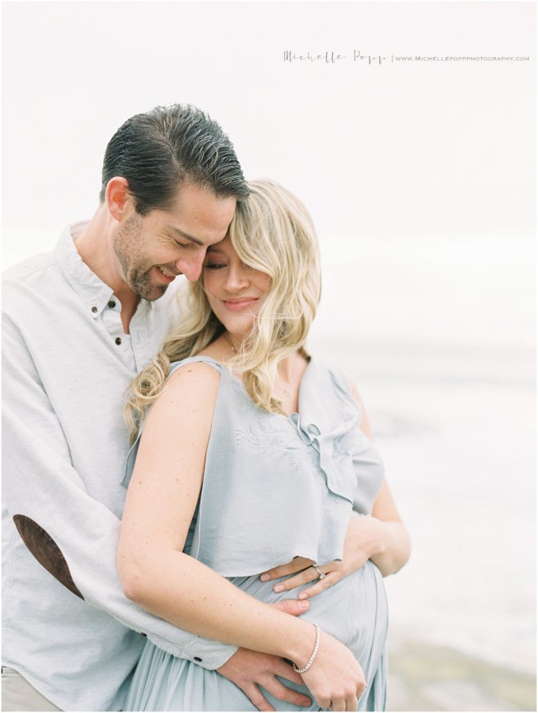 dad holding mom's baby bump