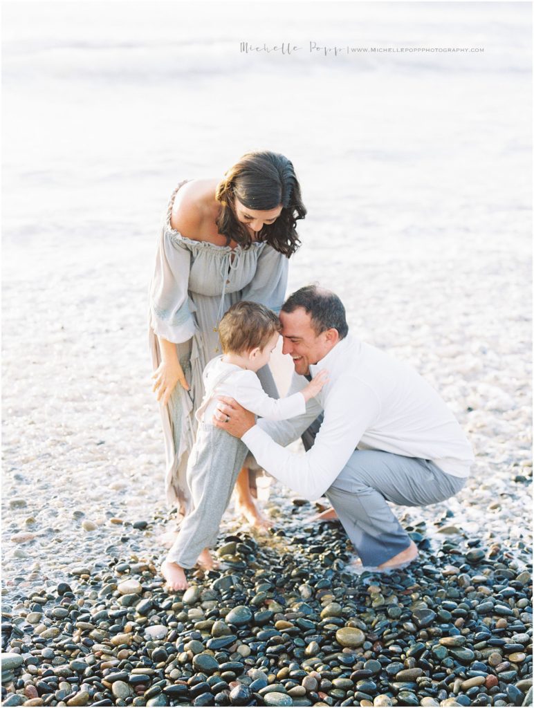 family playing in the water during beach family photos 