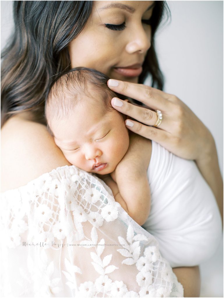 Mom snuggling with baby laying on her chest