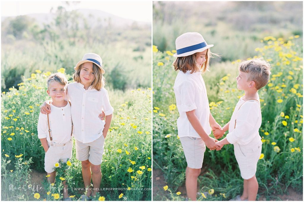 brothers holding hands in field of yellow wildflowers