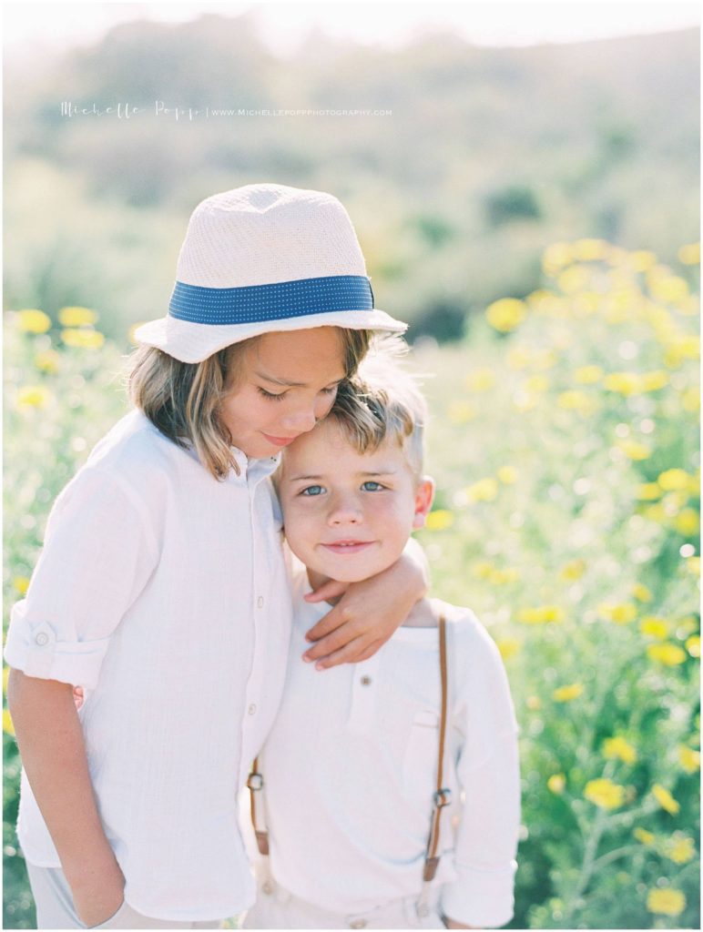 Brother hugging in San Diego wildflowers