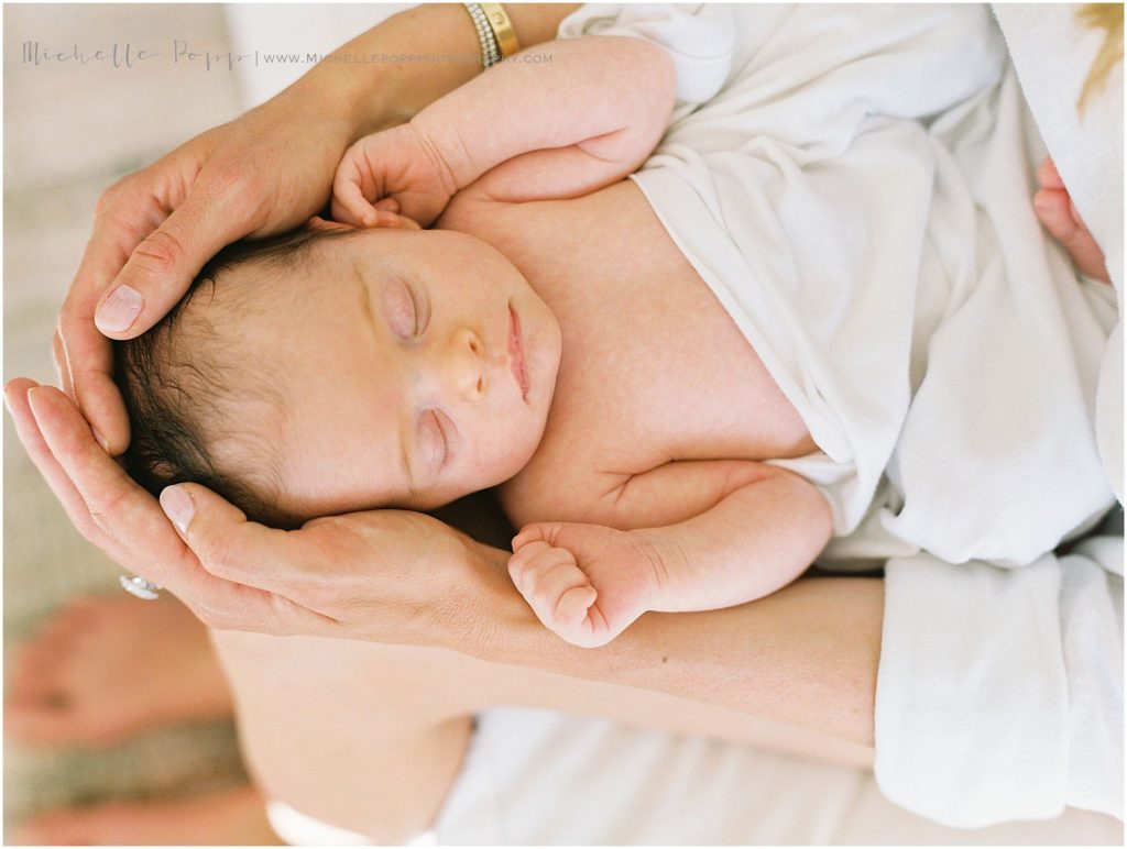 close up of baby in mom's arms